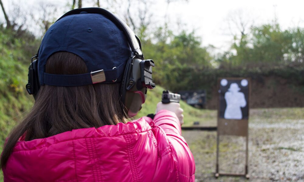 woman at a shooting range with a gun